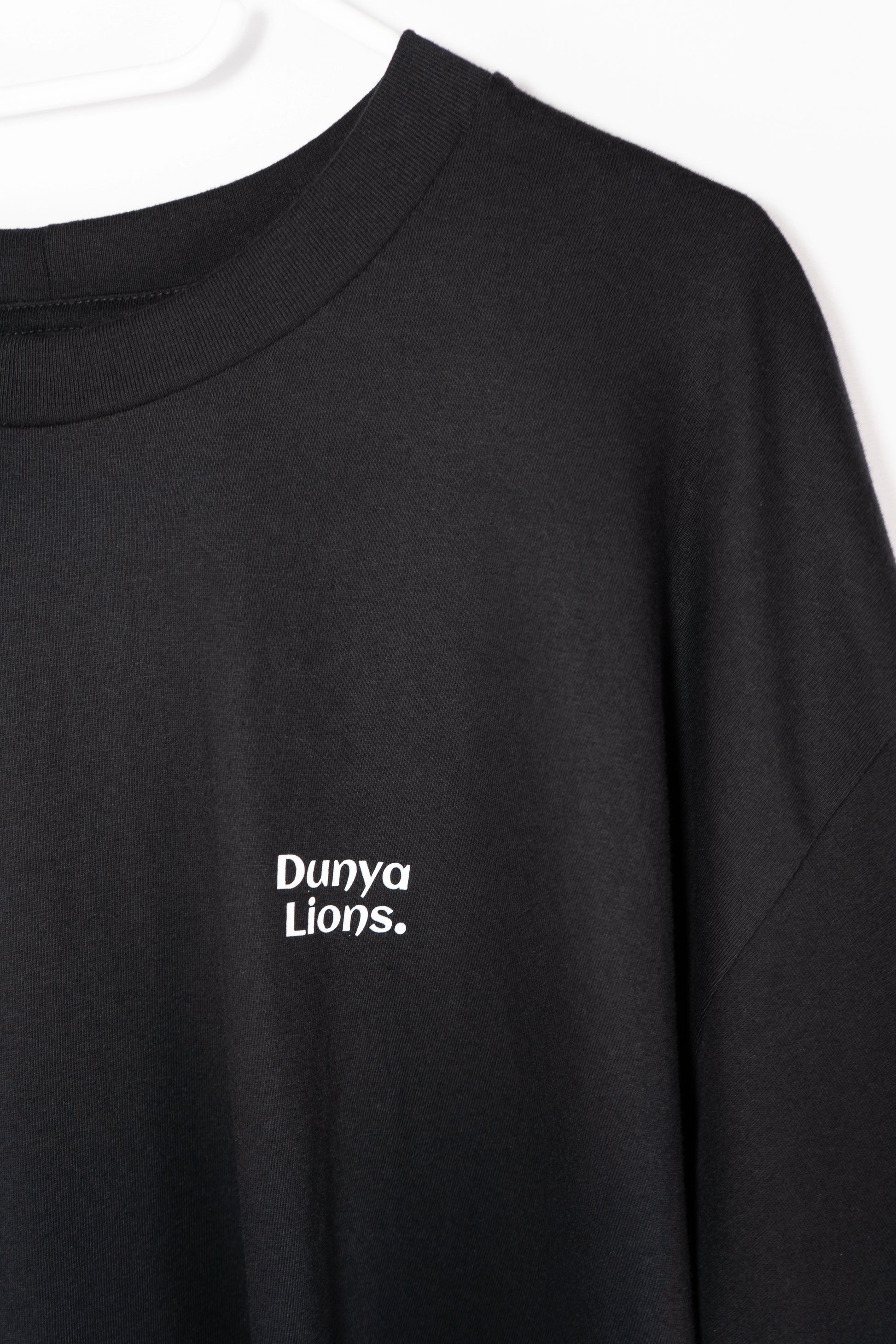 DL_Tee_Results_FrontPlain03
Alt-Text: Minimal front view of black Dunya Lions t-shirt with chest logo.