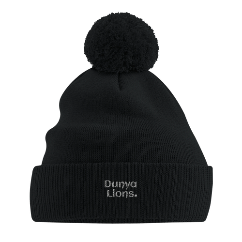 Front view of black pom-pom beanie with the bold “Dunya Lions.” embroidery — streetproof winter armor with silent presence and elite energy.