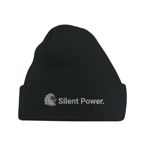 Front view of black ribbed beanie with embroidered white lion icon and the text “Silent Power.” — a timeless accessory that speaks strength without sound.