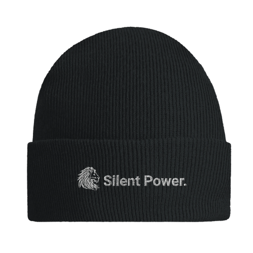 Front view of black ribbed beanie with embroidered white lion icon and the text “Silent Power.” — a timeless accessory that speaks strength without sound.